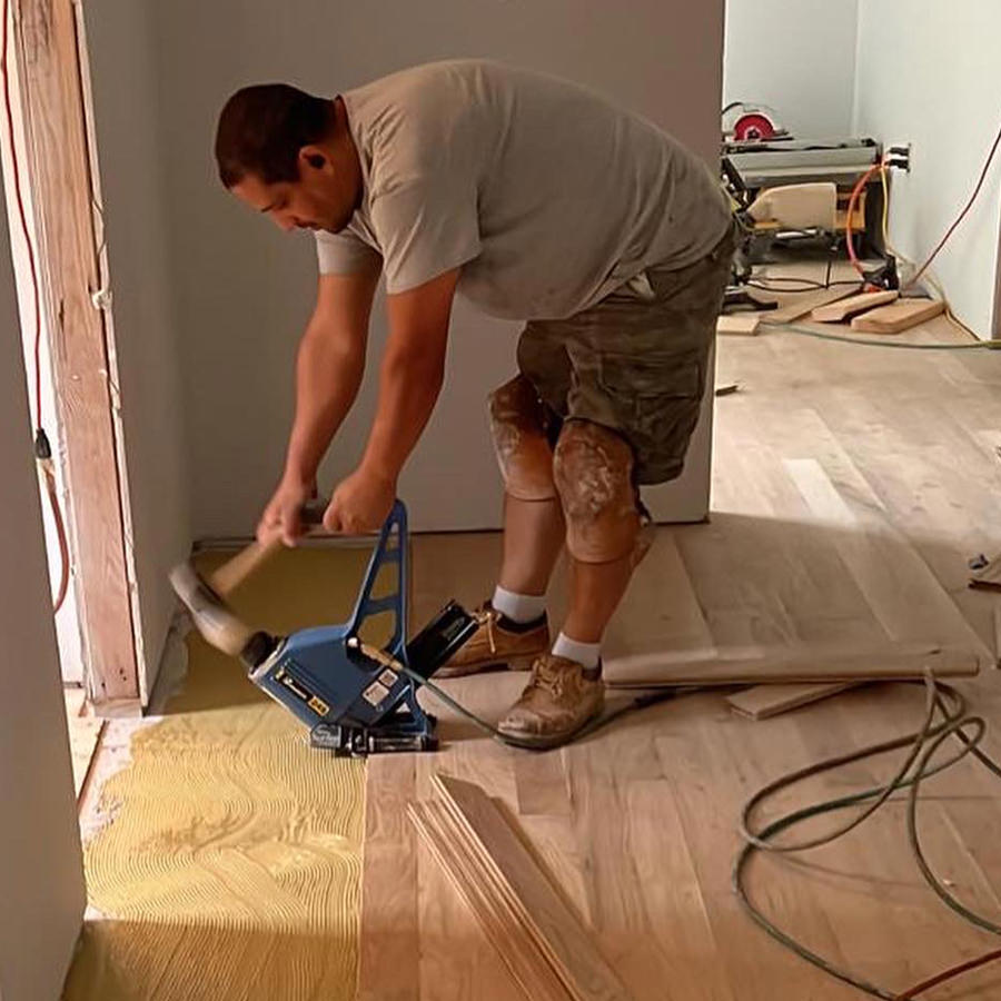 man installing a hardwood floor